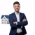 man-standing-with-crossed-arms-front-house_839153-8401